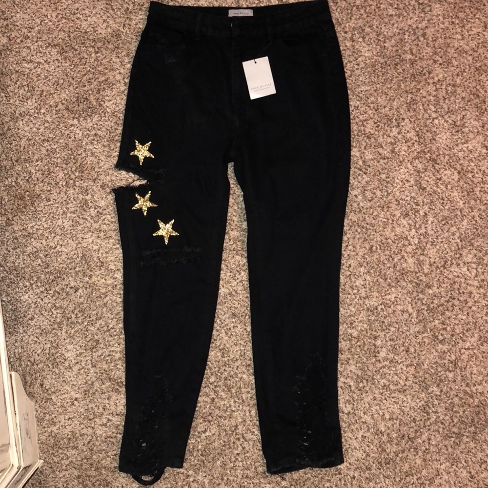 Black Distressed jeans with gold stars on right leg